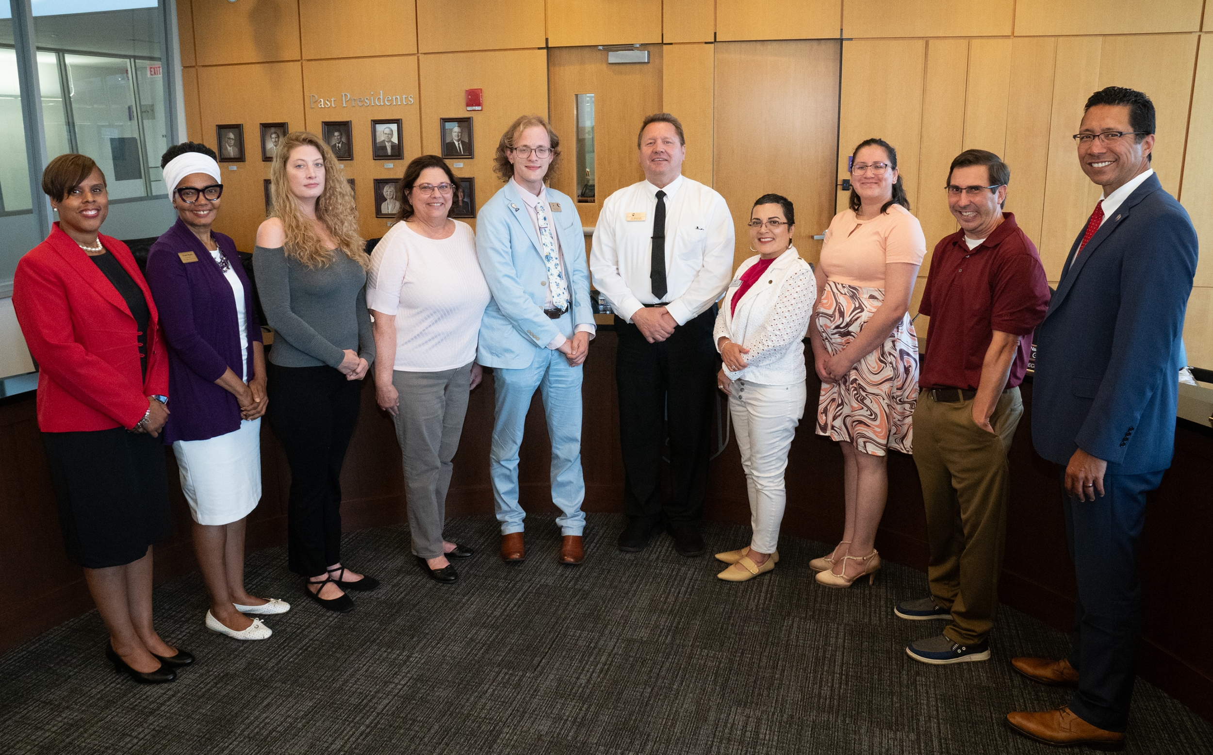 Pictured left to right are Dr. Yolanda Farmer, Diane Harris, Michelle Lee, Maureen Broderick, Ryan Queeney, James Budzinski, Nancy Garcia Guillen, Alicia Morales, Jake Mahalik and Dr. Clyne Namuo as they pose for photo in JJC board room