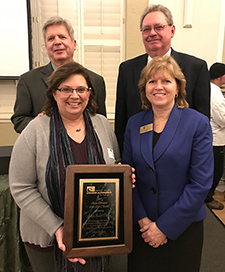 JJC President Dr. Judy Mitchell accepting the Joliet Area Chamber and Industry Business of the Year Award