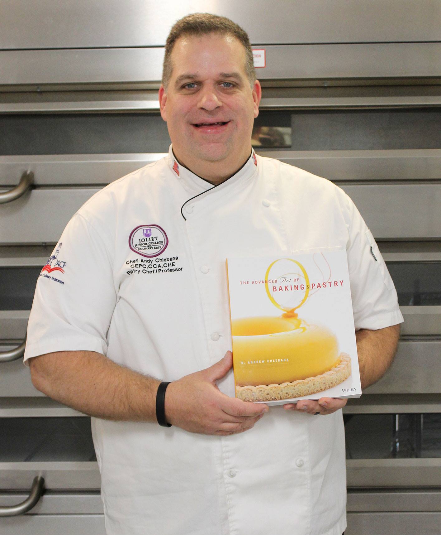JJC professor of culinary arts, Andy Chlebana, holds a copy of his new textbook.