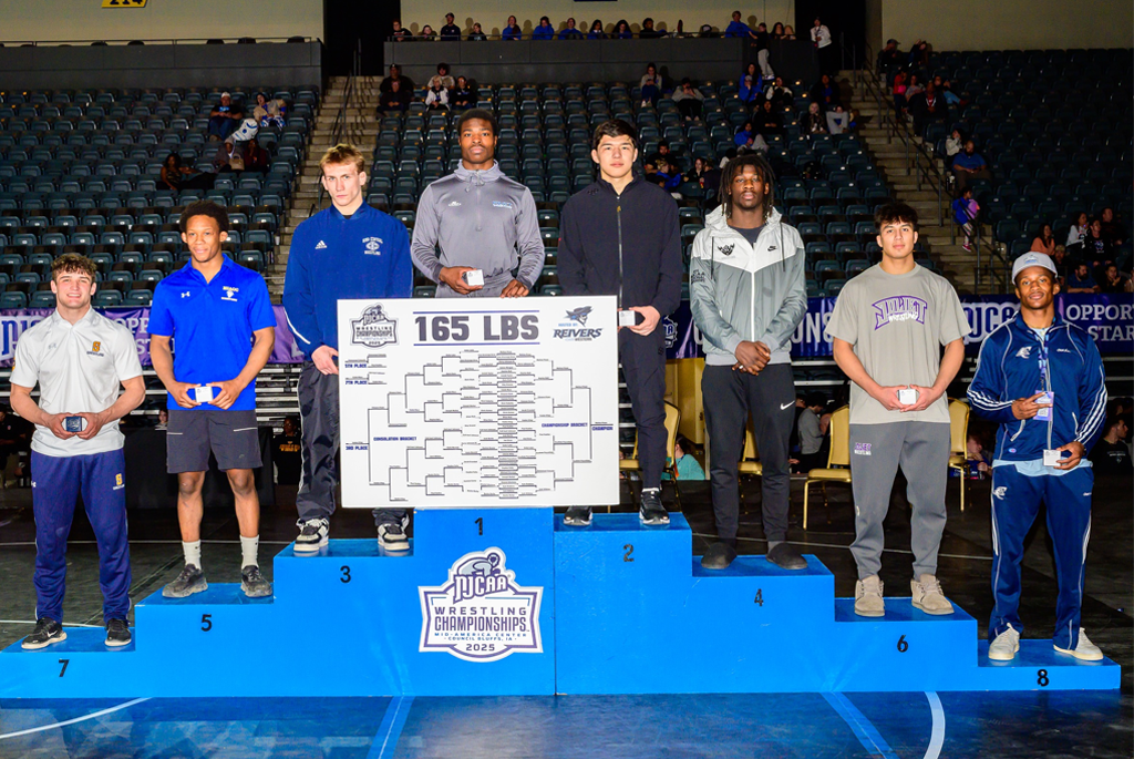 eight people in 165 lb division stand on podiun after wrestling meet