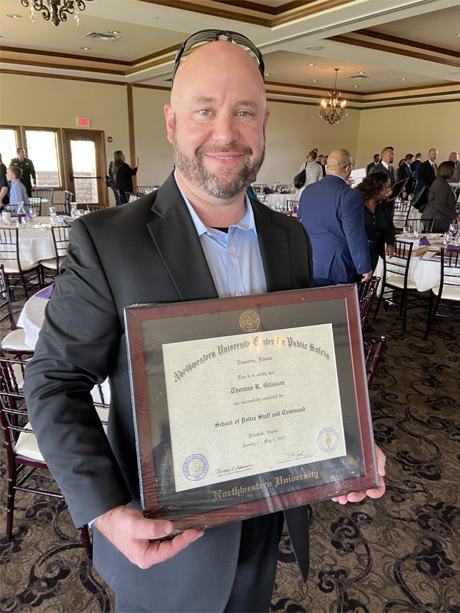 Sergeant Tom Glisson holds diploma