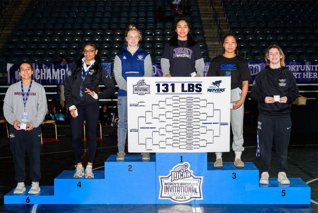 six people in 131 lb division stand on podiun after wrestling meet