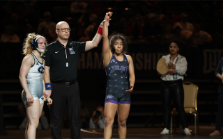 referee holds up Katie Ramirez-Quintero's arm in victory after match