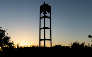 silhouette of bell tower during sunset