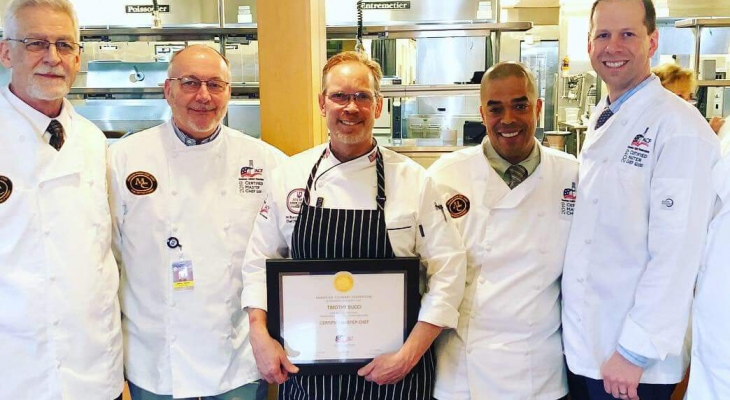 Chef Tim Bucci holding CMC certificate 