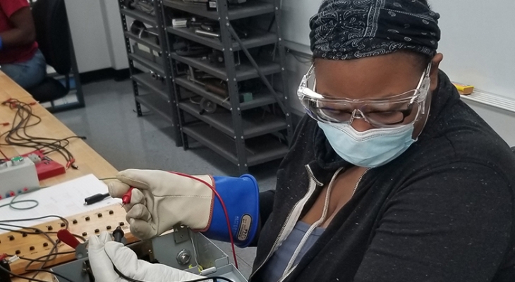 student working with electrical wires