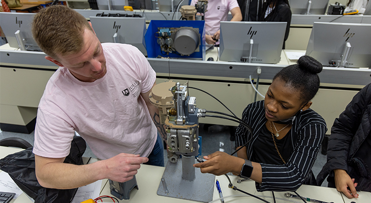 two people in a technical lab