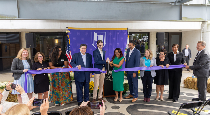 a group of elected officials cut the purple ribbon at the center for student wellness