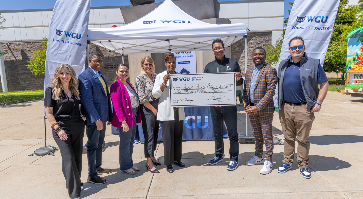 JJC and WGU leaders stand with scholarship check outside