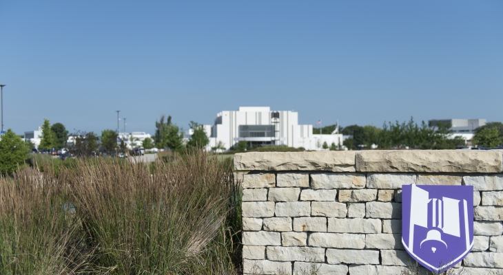 JJC shield with a building in background