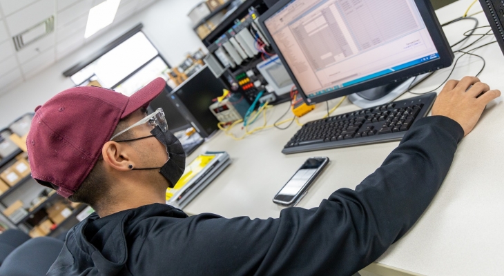 Student at desk with mask