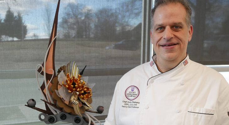 Chef Andy Chlebana poses for photo with his chocolate piece