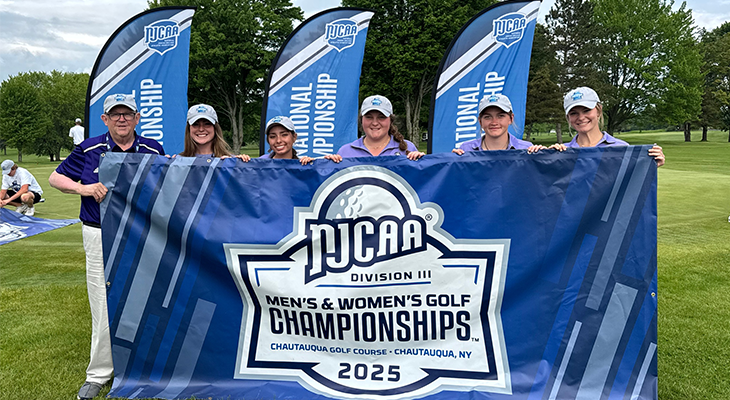 six people pose with national championship banner outdoors on golf course