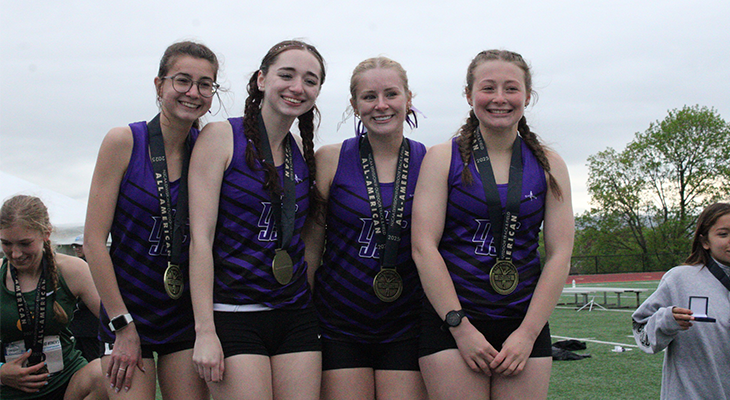 four JJC track athletes pose for photo with medals