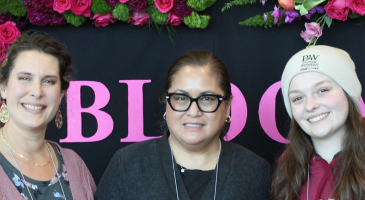 three people pose for photo