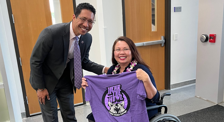 Dr. Clyne Namuo poses for photo with U.S. Senator Tammy Duckworth, holding a JJC Hear the Howl shirt