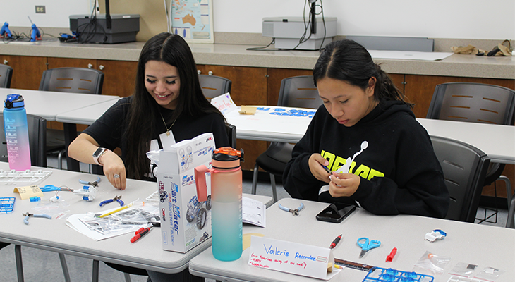 two girls assemble a STEM project
