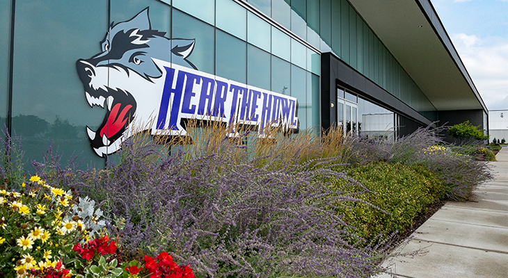 Hear the howl wolf decal on side of building