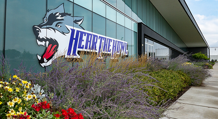 hear the howl wolf window decal and flowers outside building