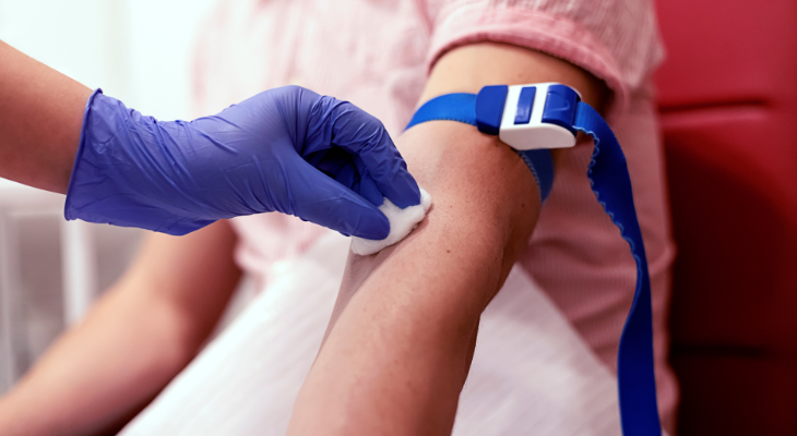 cotton ball on arm after donating blood