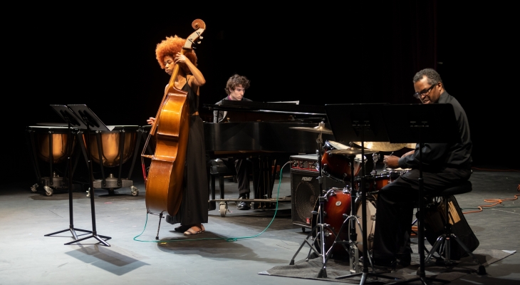 musicians playing piano, cello and drums on stage