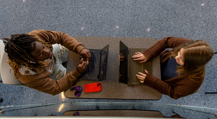aerial view of two students using laptops